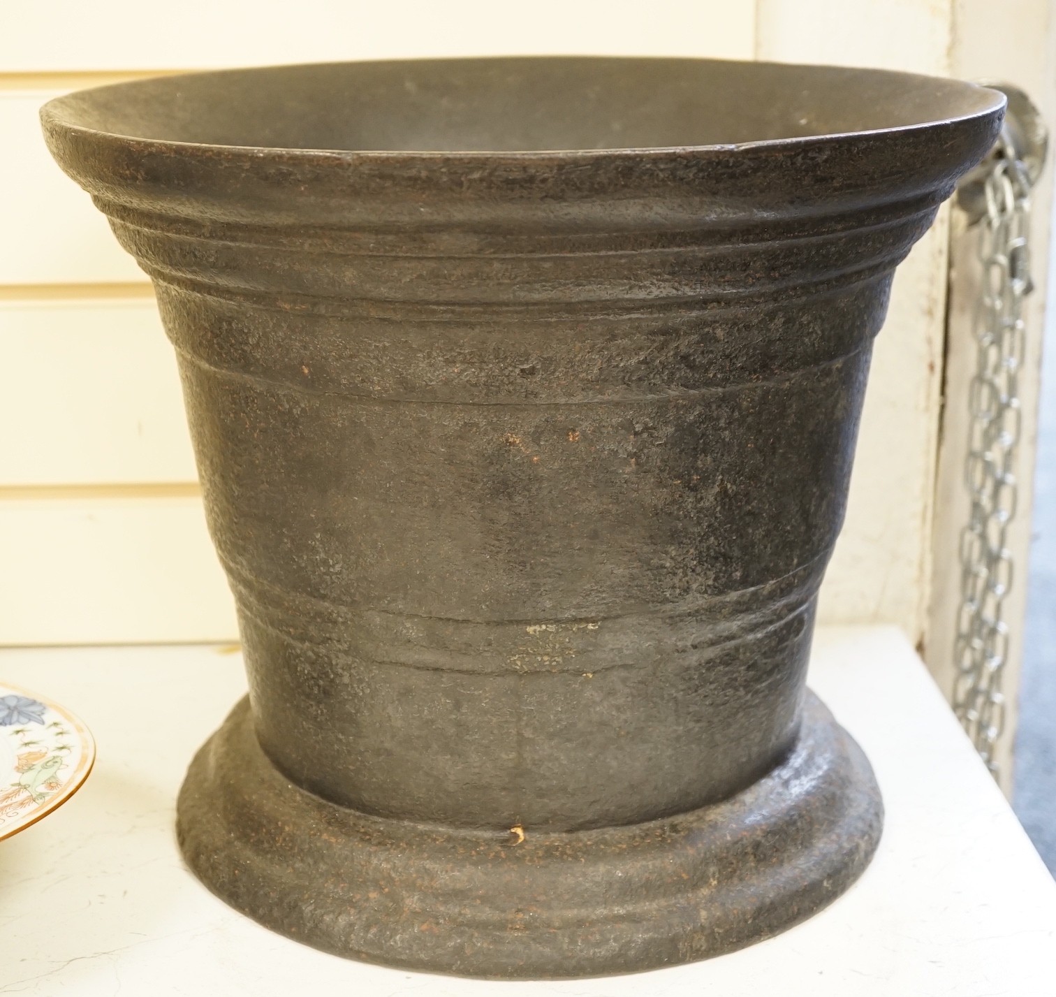 A large cast iron mortar Height 29 cm Width 36 cm